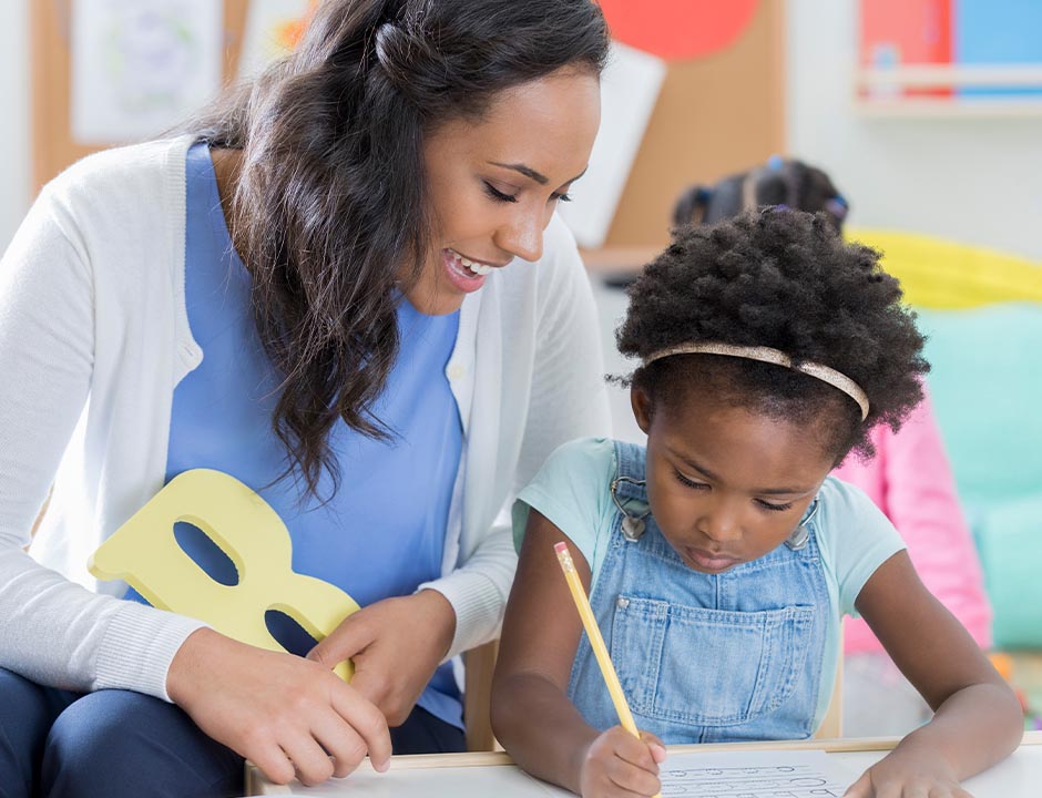 Teacher and student practicing handwriting